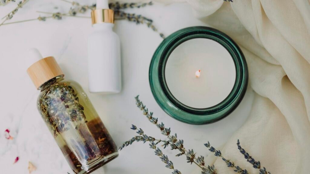 A calming flat lay of spa essentials featuring lavender and candles for relaxation.