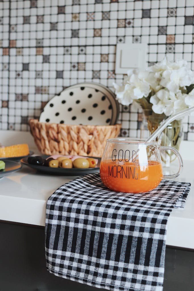 Elegant breakfast setup with orange juice and fresh decor on a kitchen counter.